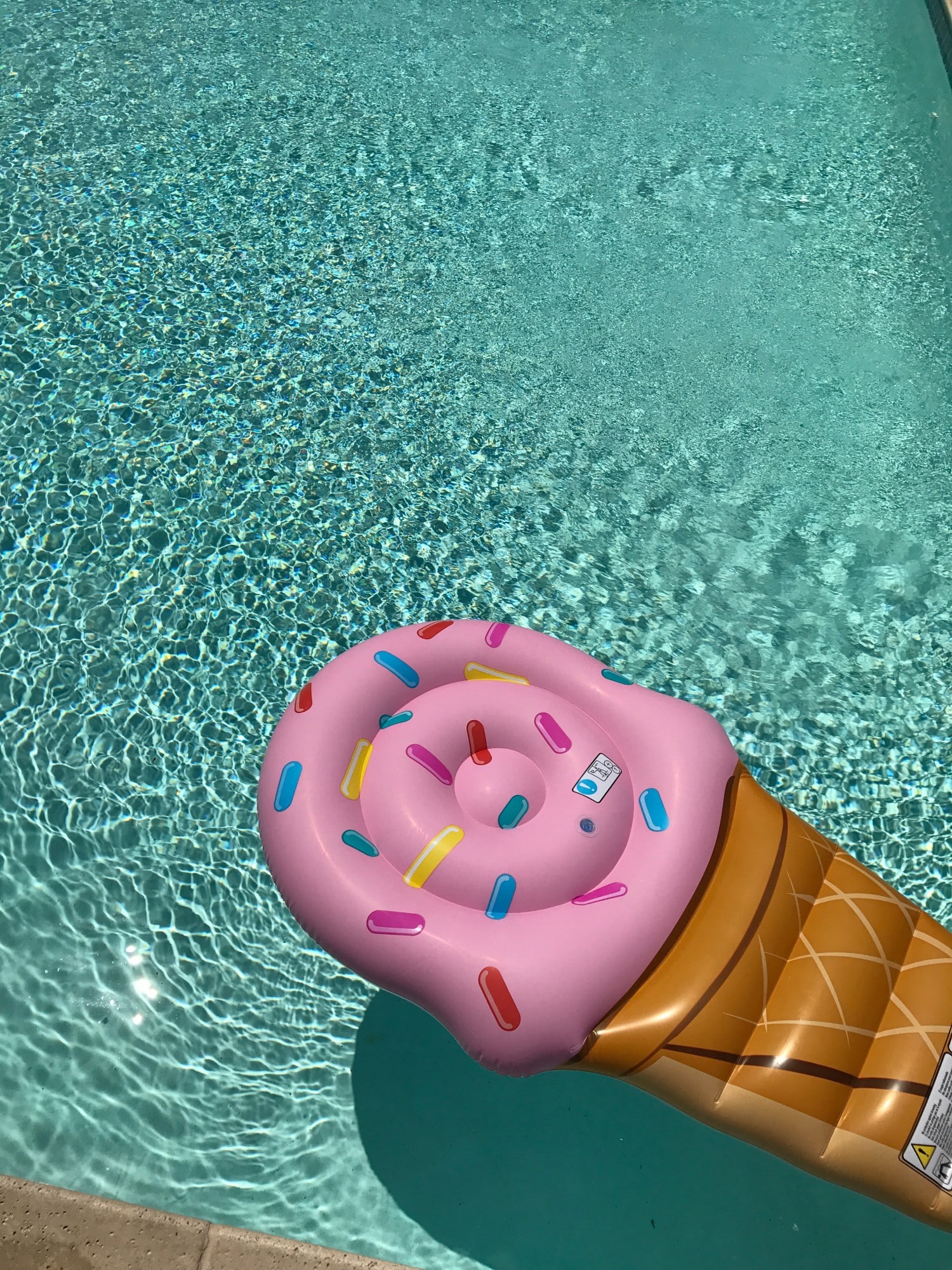 Pool float for a summer staycation. Read our full guide to creating the perfect staycation now.