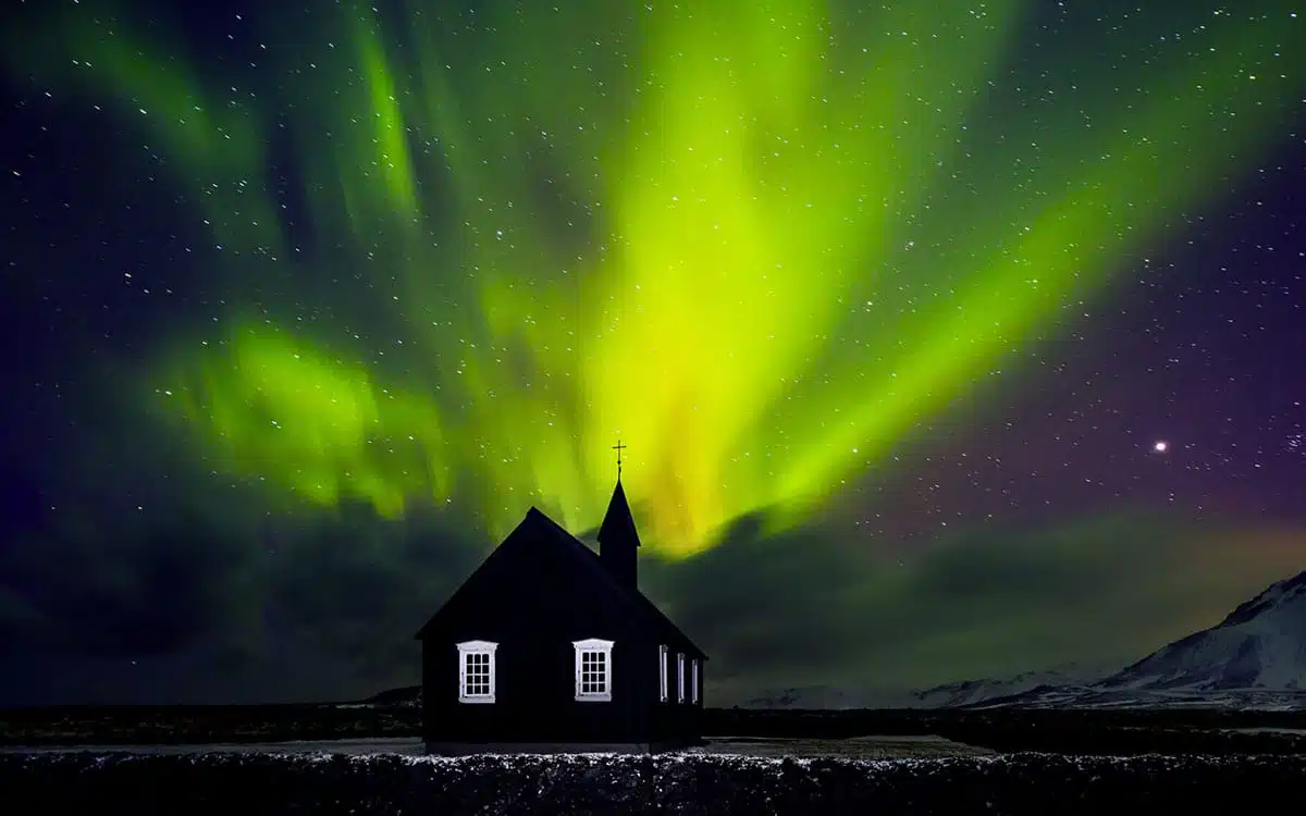 Northern lights behind a house