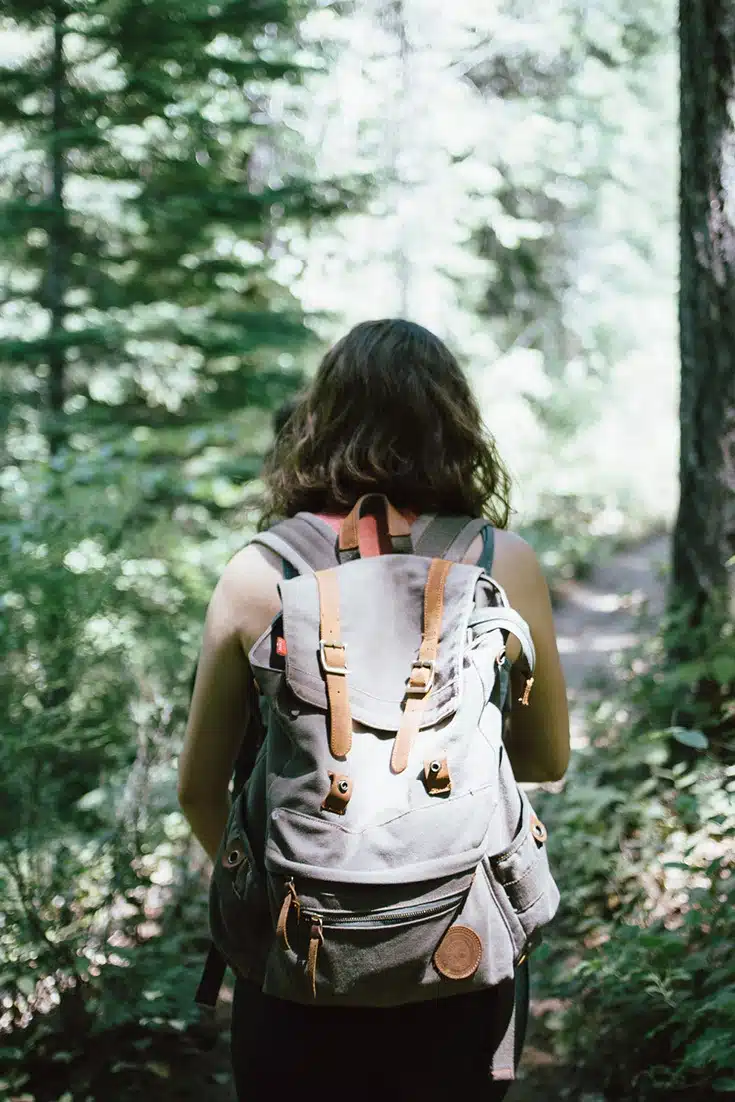 Girl in the woods with backpack on