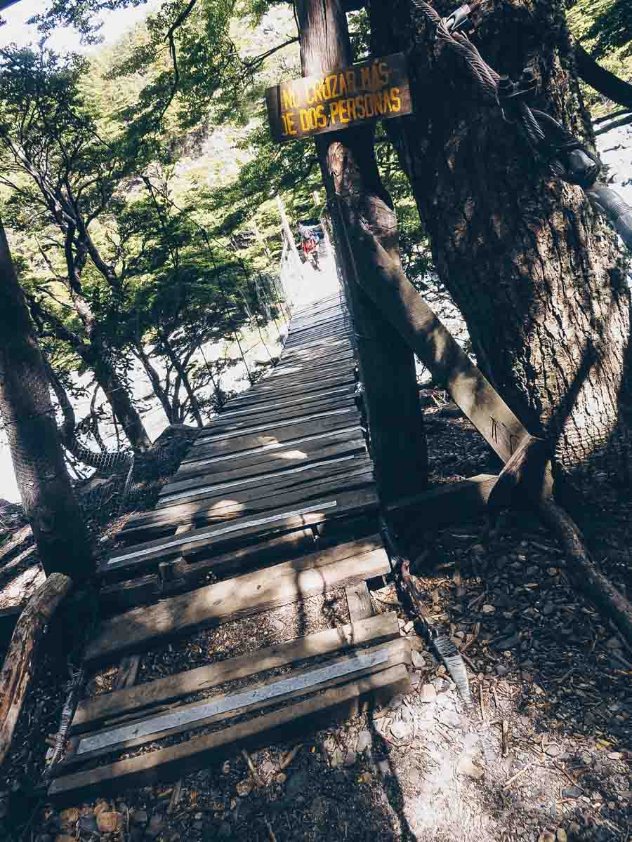 Crossing a wooden bridge over a river