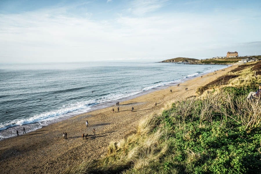 Surfers out on Fistral Beach Cornwall