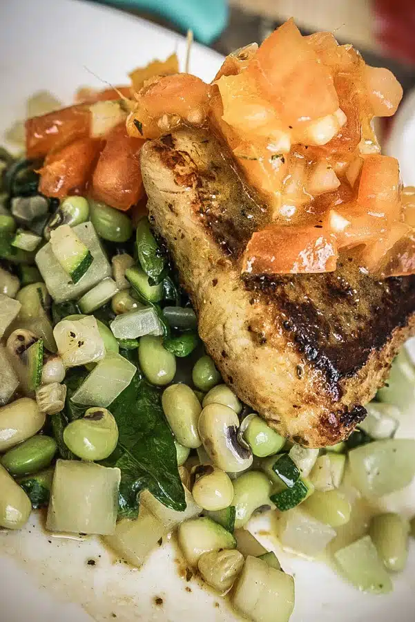 Mahi Mahi with vegetables and a tomato salsa. Dreaming of a Caribbean vacation? Nevis is the coolest island in the Caribbean - with a laid-back aesthetic, gorgeous beaches, vibrant culture and cool style and amazing food. Check out my foodie's guide to what to eat and drink in Nevis #travel #caribbean #traveldestinations