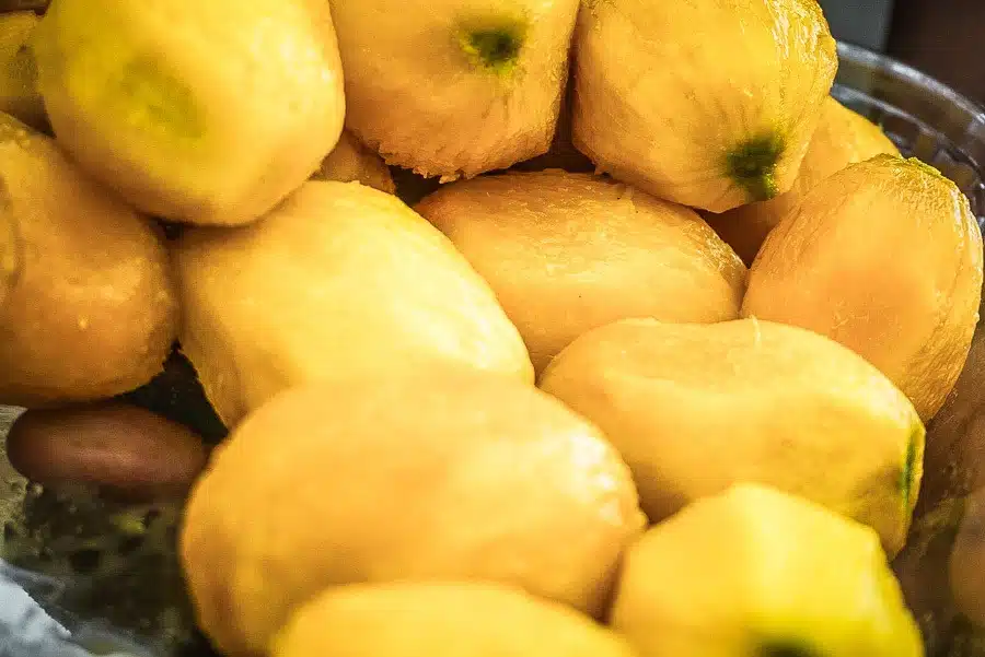 Peeled and ripe mangoes ready to eat. Dreaming of a Caribbean vacation? Nevis is the coolest island in the Caribbean - with a laid-back aesthetic, gorgeous beaches, vibrant culture and cool style and amazing food. Check out my foodie's guide to what to eat and drink in Nevis #travel #caribbean #traveldestinations