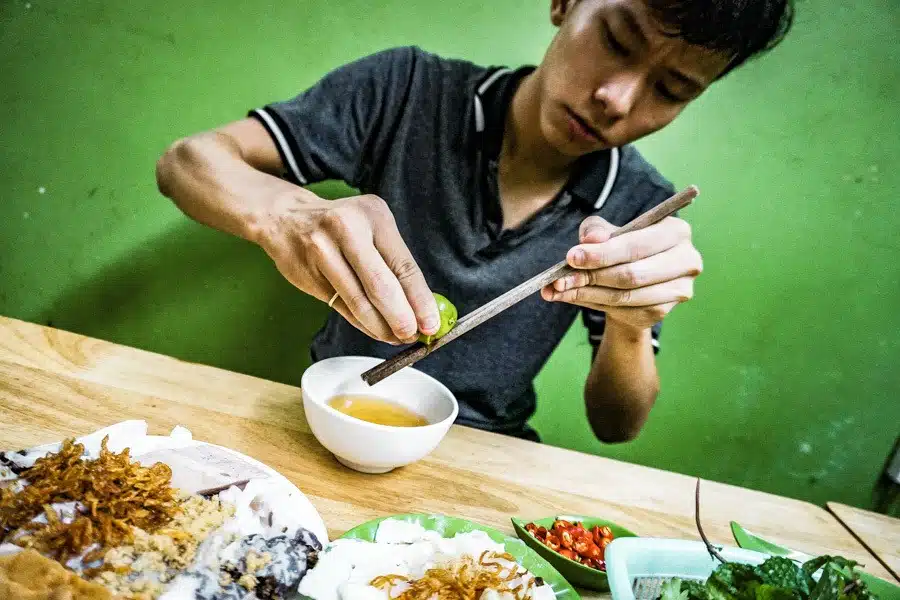 Eating Vietnamese dumplings in Hanoi. Heading to Hanoi, Vietnam? A street food tour should be at the top of your list of things to do. The ultimate self-guided street food tour of the Old Quarter. Don't miss it! #travel #vietnam #food