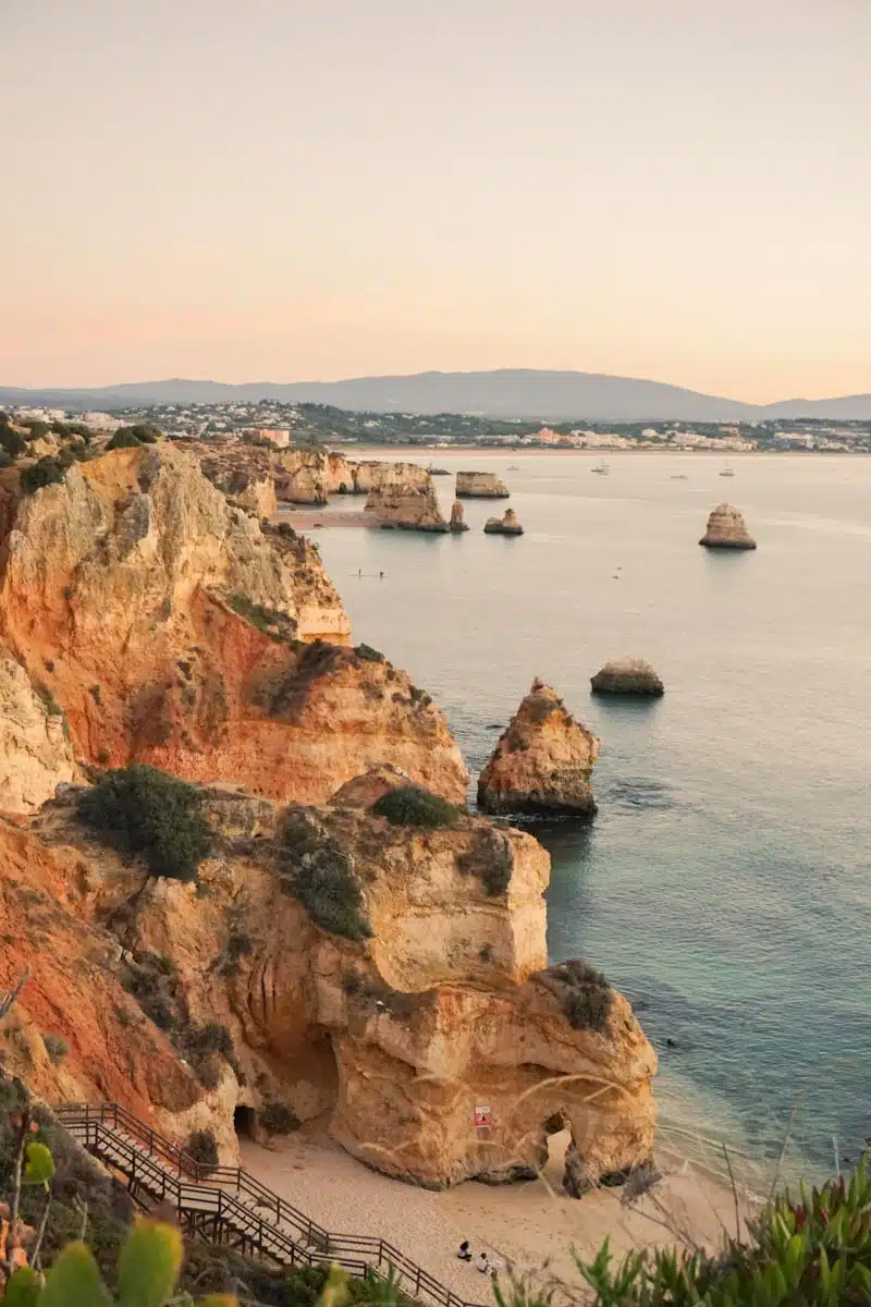 Golden limestone cliffs and sea stacks rising from turquoise water at Ponta da Piedade near Lagos in the Algarve