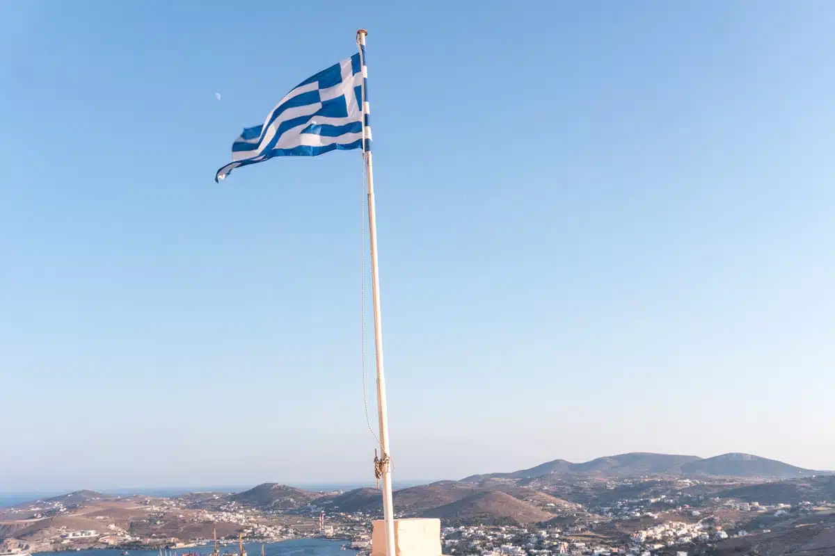 Greek flag waving above Ermoupoli