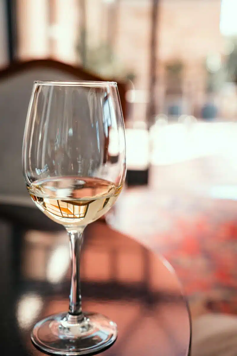 Glass of white wine on a table in the sunlit tasting room at Casa Viñamar, Casablanca Valley