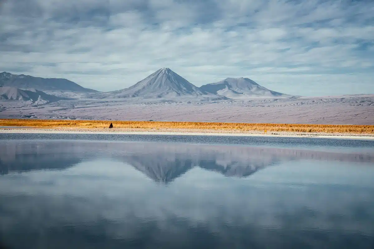 Licancabur and neighbouring volcanoes reflected in the still water of the lagoons at Laguna Cejar