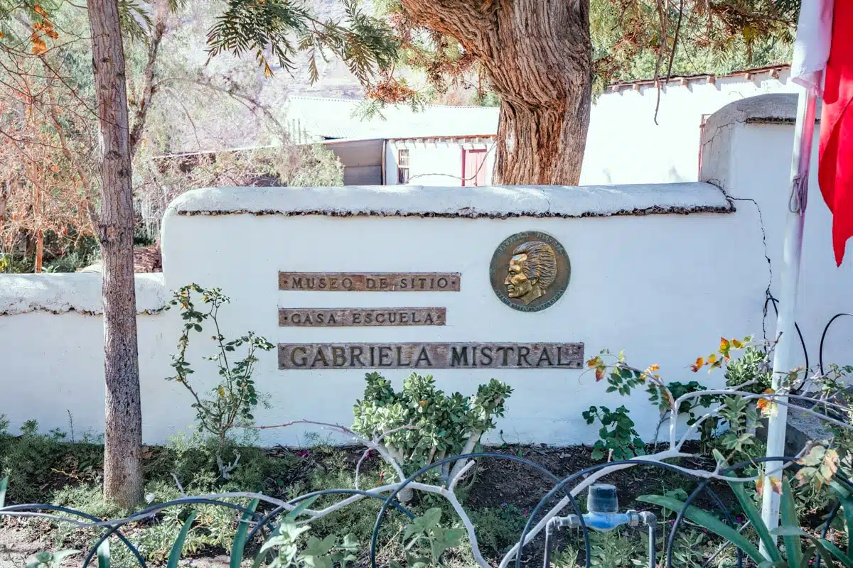 White wall with the sign for the Casa Escuela Gabriela Mistral museum in Montegrande, Elqui Valley