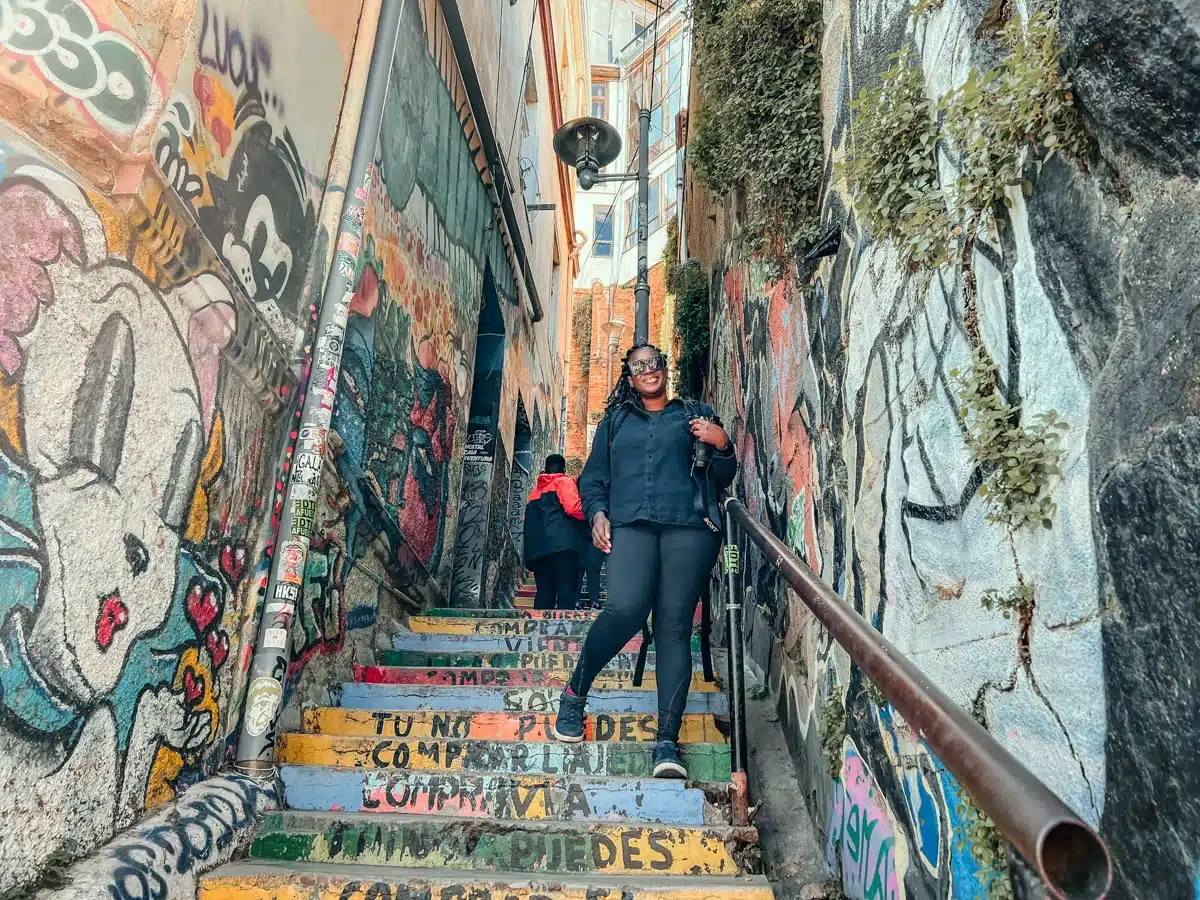 Julianna on the brightly painted stairs of Cerro Concepción in Valparaíso, Chile