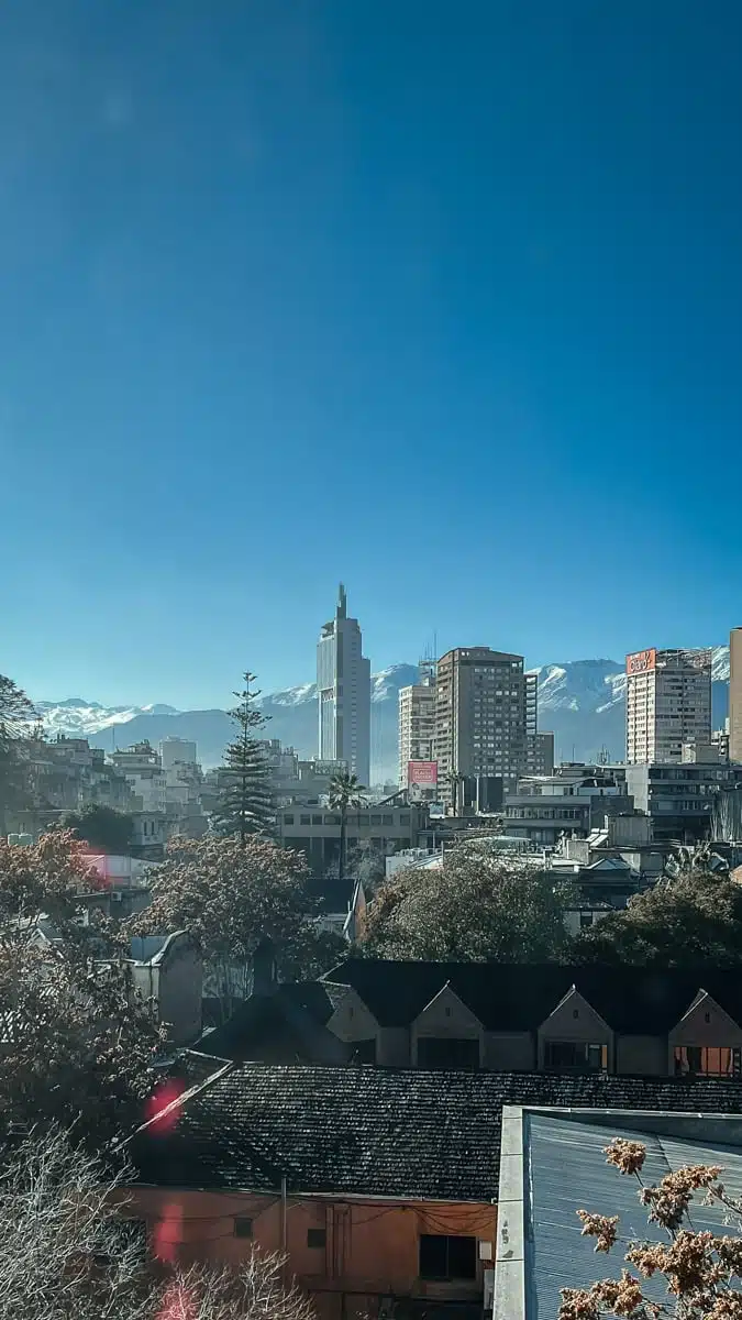 Santiago rooftops, trees and high-rise towers under a clear blue sky on a winter morning, Chile