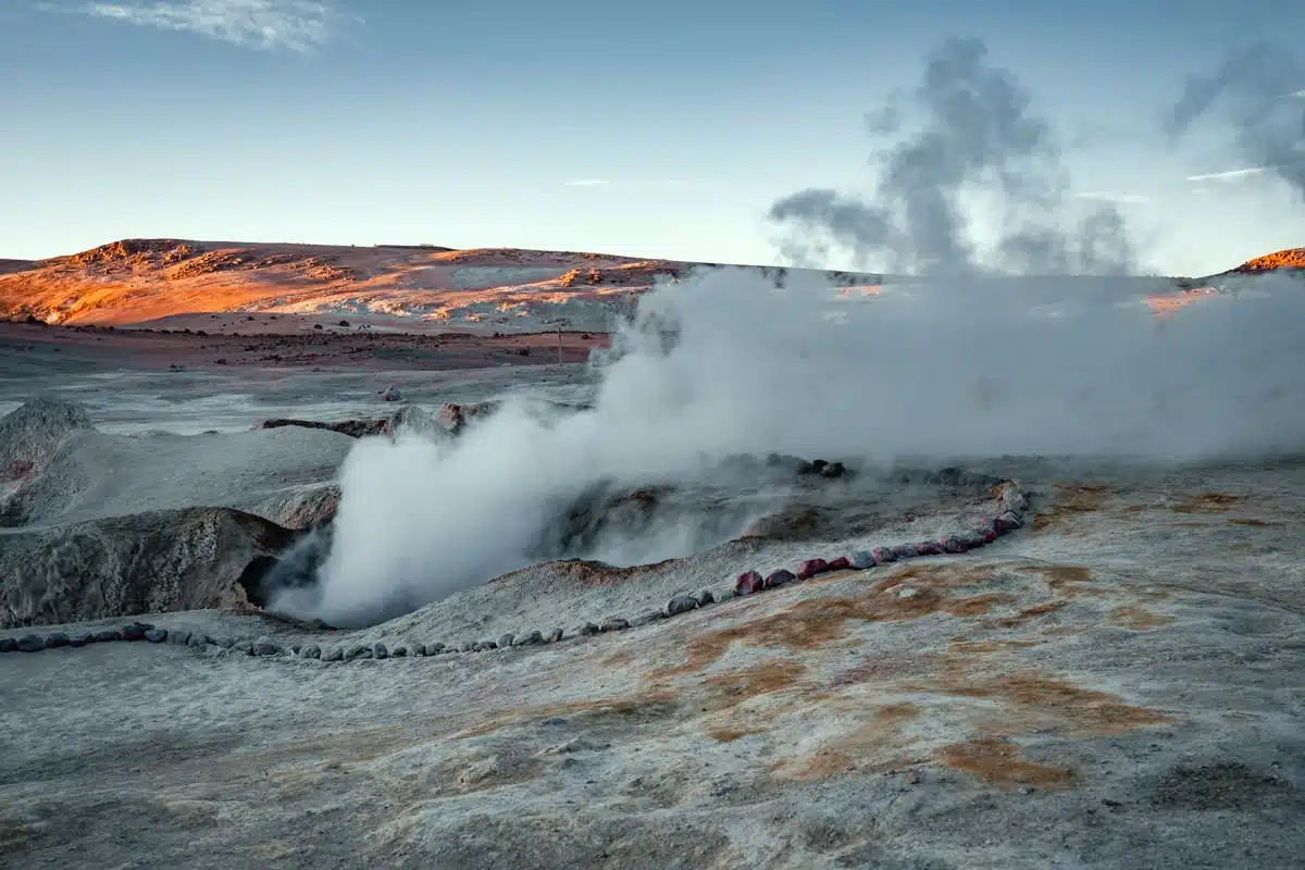 Clouds of steam rising from fumaroles and mud pools at the Sol de Mañana geysers, Bolivia