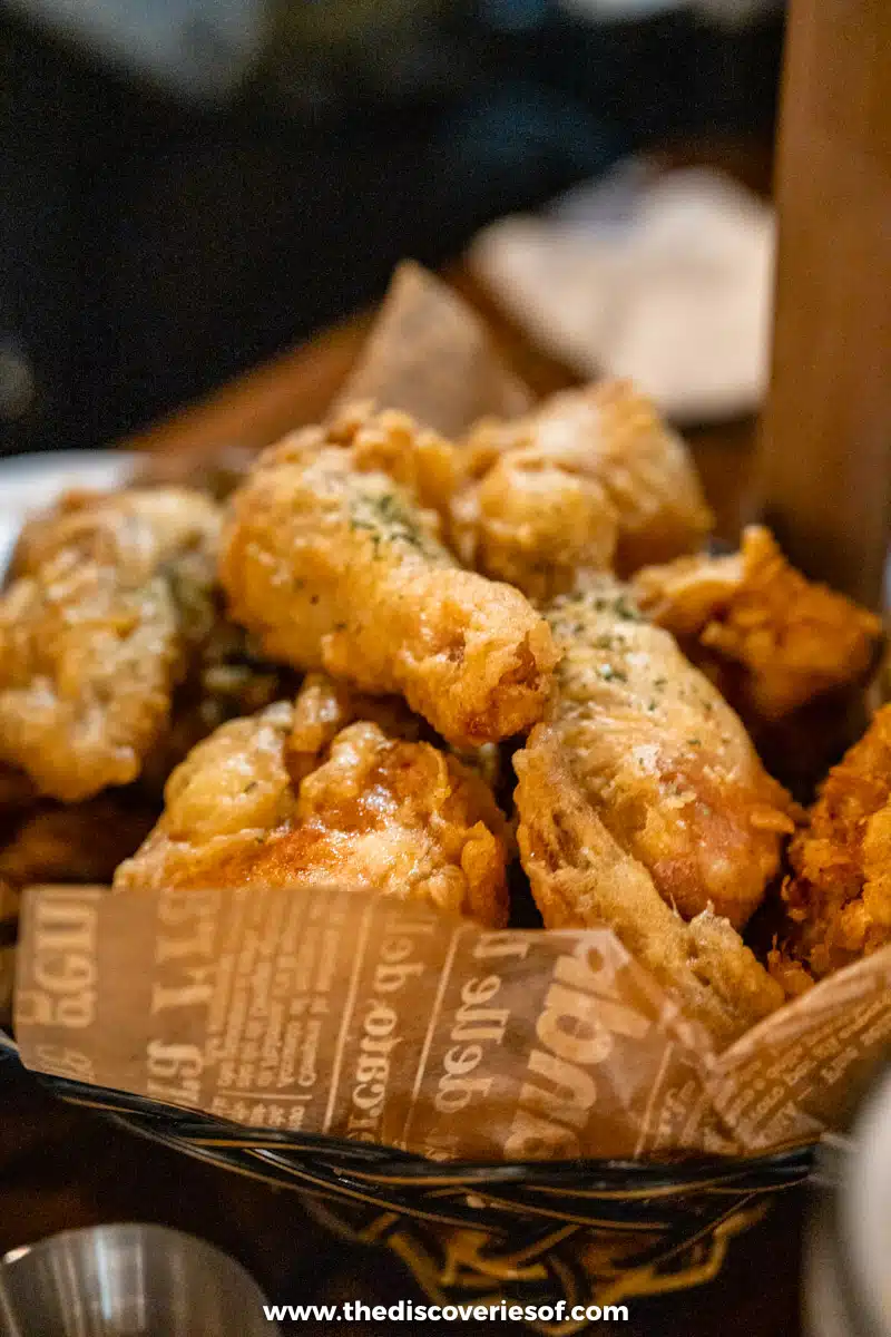 A basket of crisp golden Korean fried chicken sprinkled with herbs at a restaurant in Mokpo