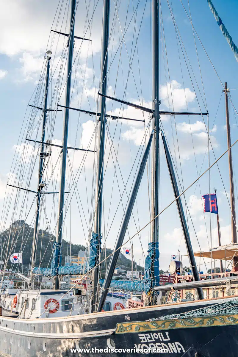 The masts and rigging of the tall ship Koreana moored in Mokpo harbour under a blue sky