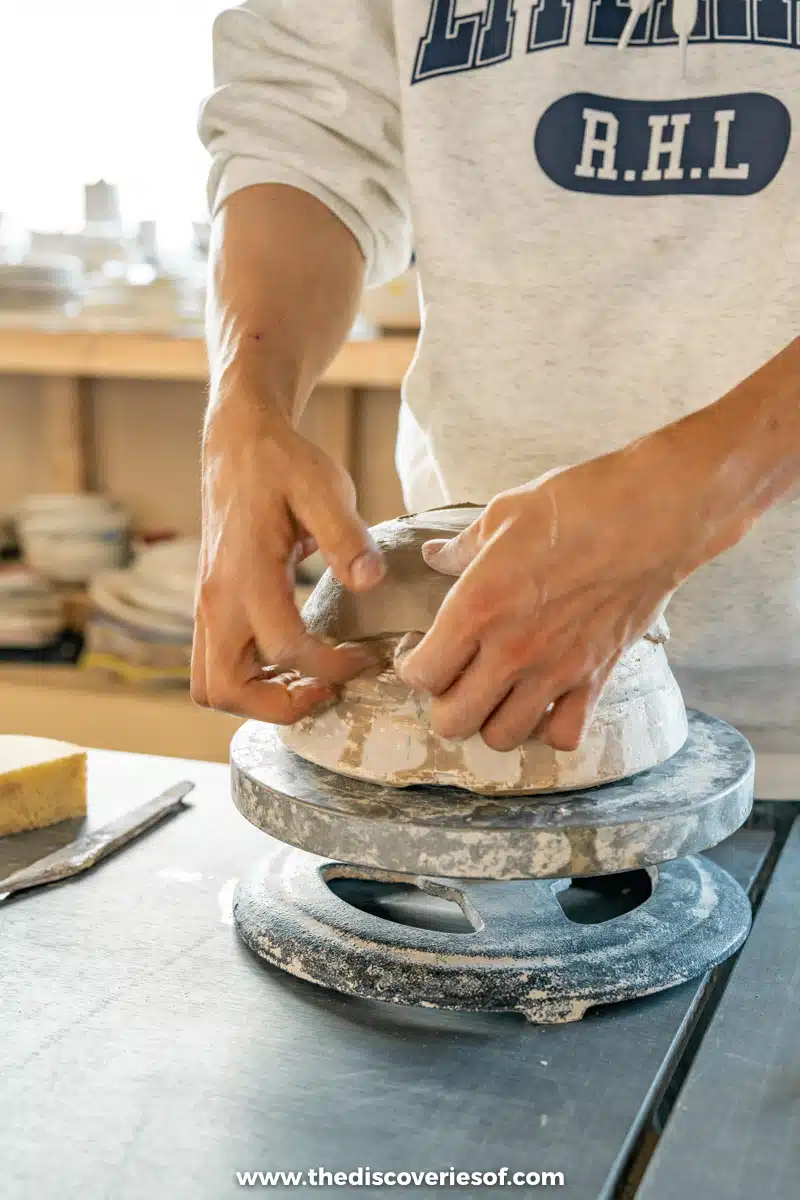 Hands shaping a piece of clay on a pottery wheel at the Object U studio in Jeonju