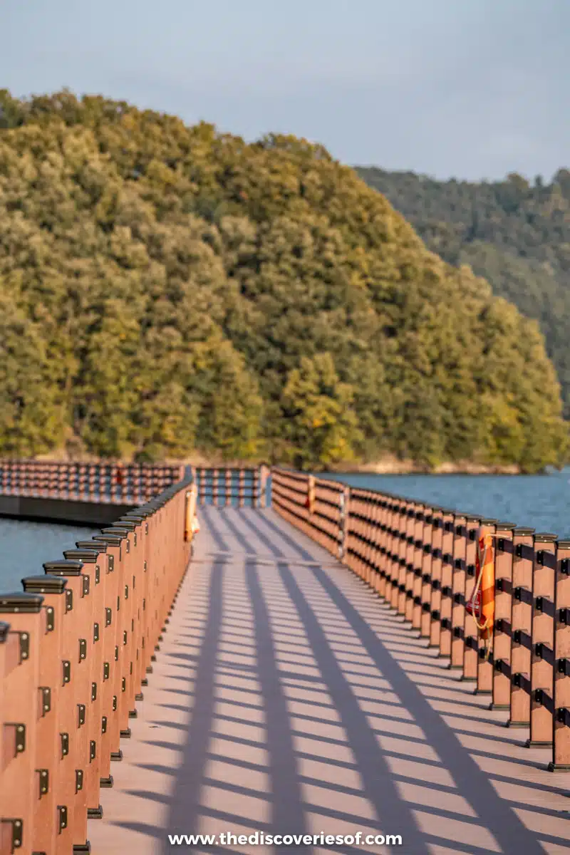 The wooden Seonseong floating walkway stretching across Andong Lake towards wooded hills