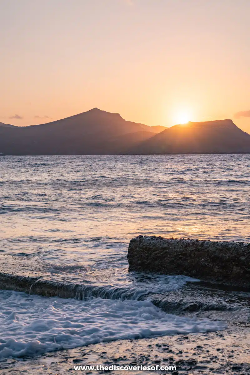 The sun dips behind the mountains