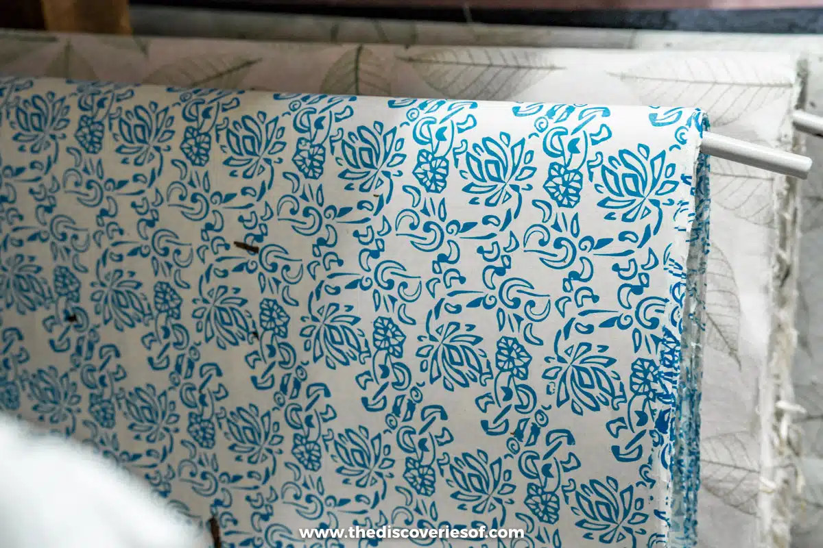 A sheet of handmade hanji paper printed with blue floral patterns hanging up to dry in Jeonju