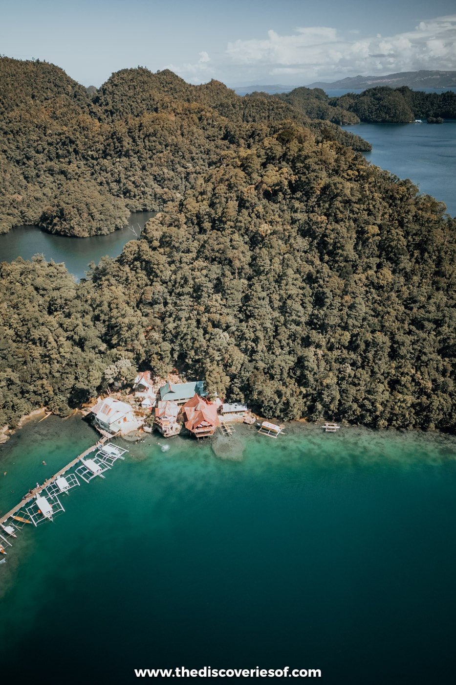 Aerial view of Sugba Lagoon with its floating house below forested limestone hills, Del Carmen, Siargao
