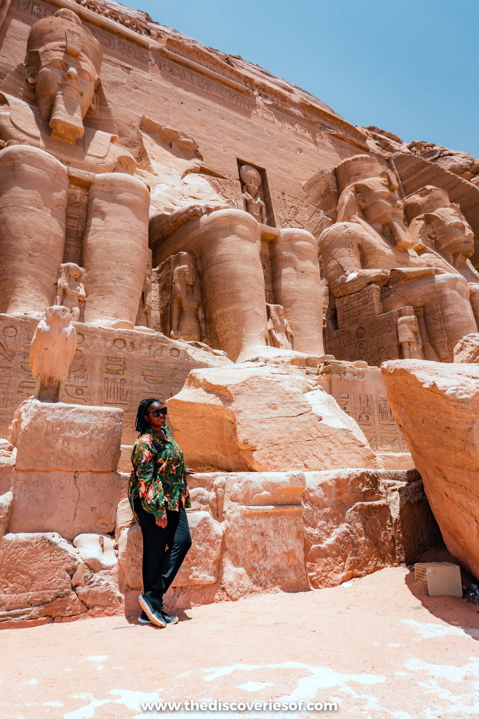Julianna standing at the foot of the colossal statues of Ramses II at the Great Temple of Abu Simbel