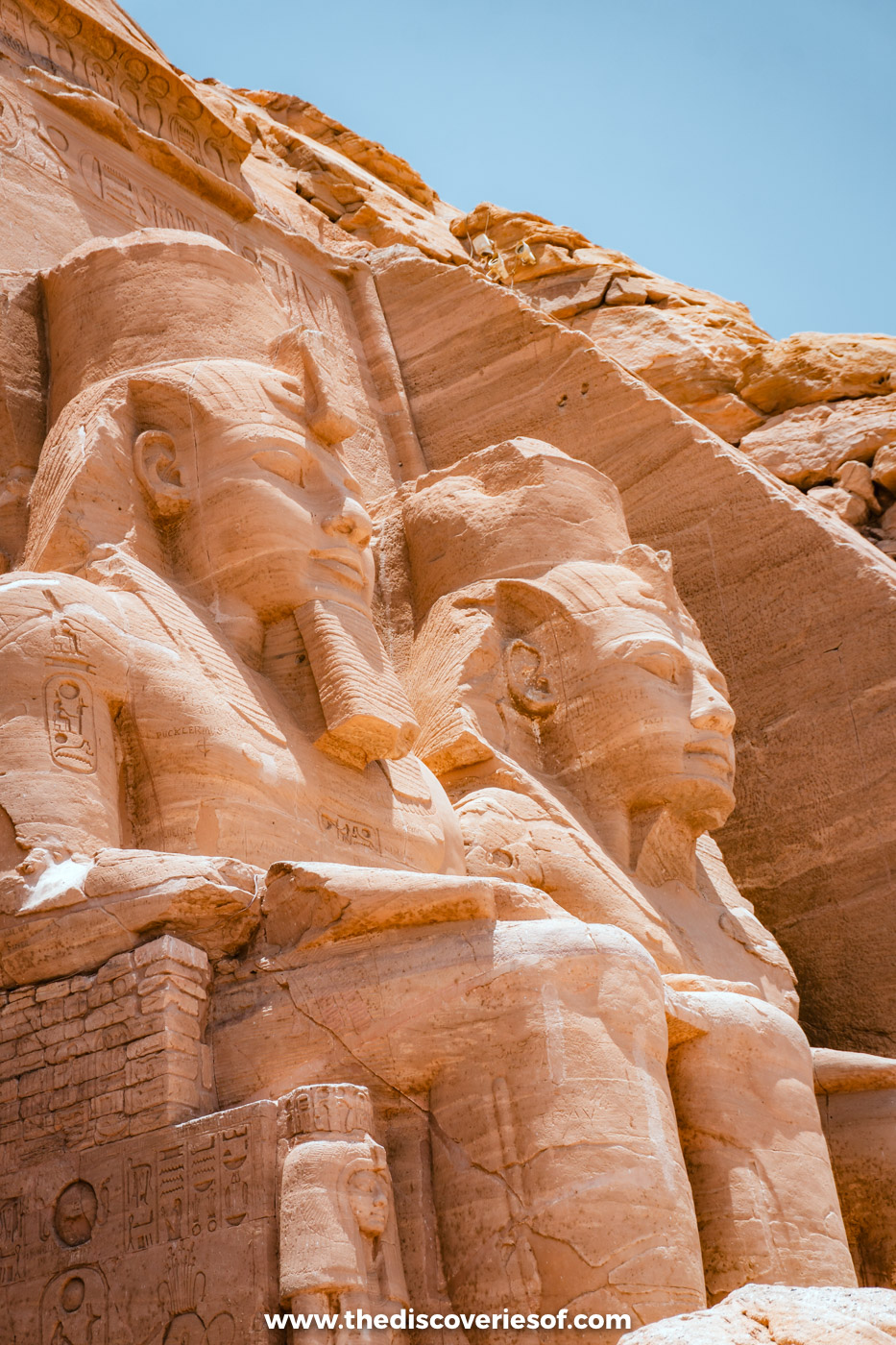 Two of the colossal seated statues of Ramses II carved into the facade of the Great Temple at Abu Simbel