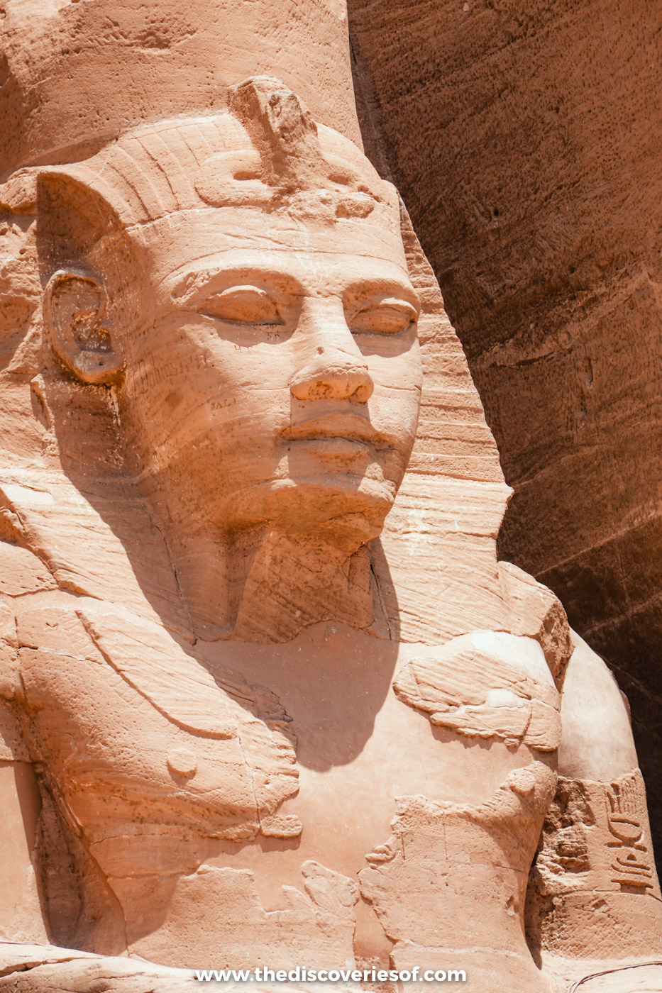 Close-up of the carved face and nemes headcloth of a colossal statue of Ramses II at Abu Simbel