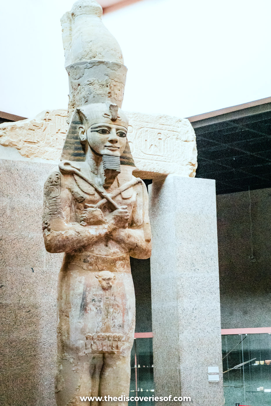 A colossal standing statue of Ramses II with crossed arms and double crown in the Nubian Museum, Aswan