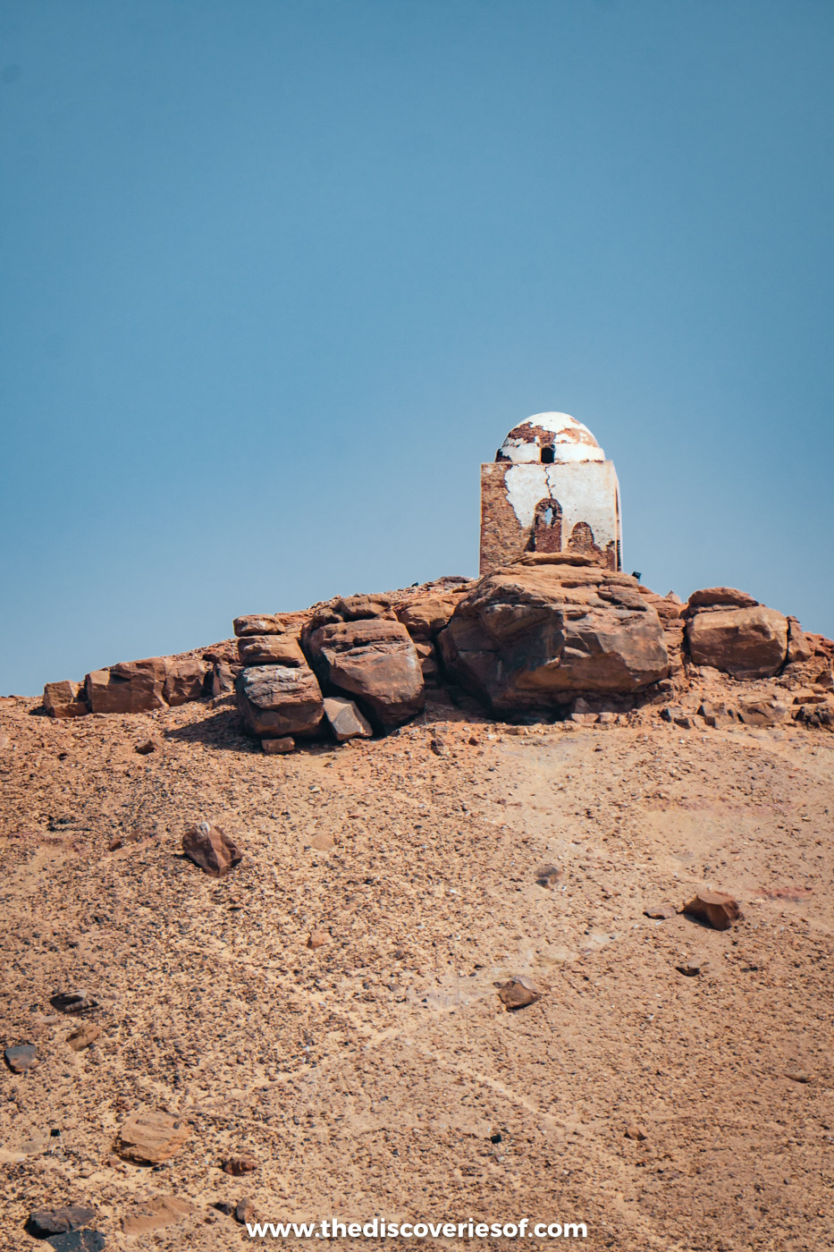 The small white domed tomb of Qubbet el-Hawa on a rocky summit above the Tombs of the Nobles, Aswan