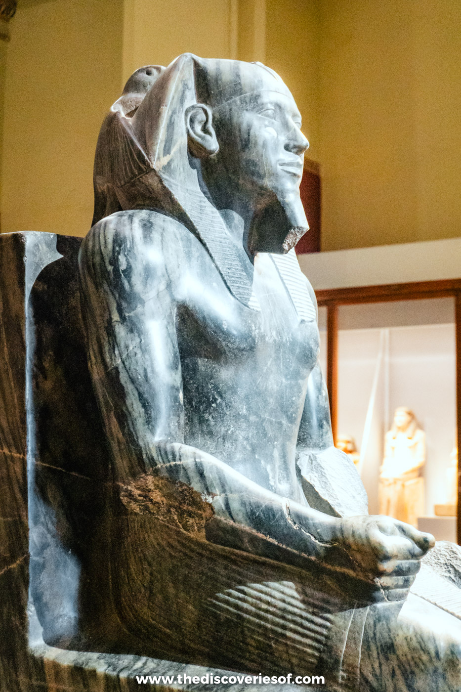 The dark stone seated statue of the pharaoh Khafre on display in the Egyptian Museum in Cairo