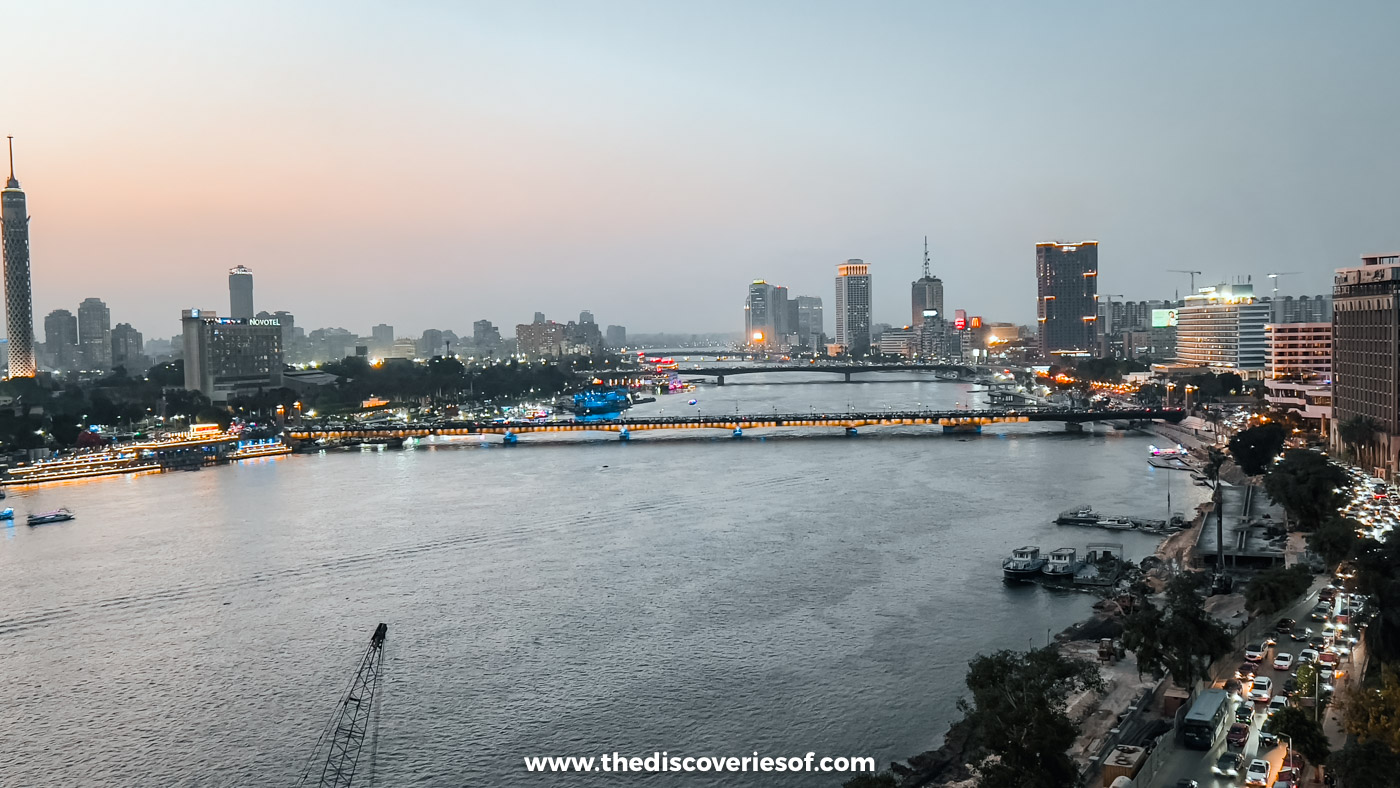 City lights along the Nile and the bridges to Zamalek at dusk, seen from the Kempinski Nile Hotel rooftop