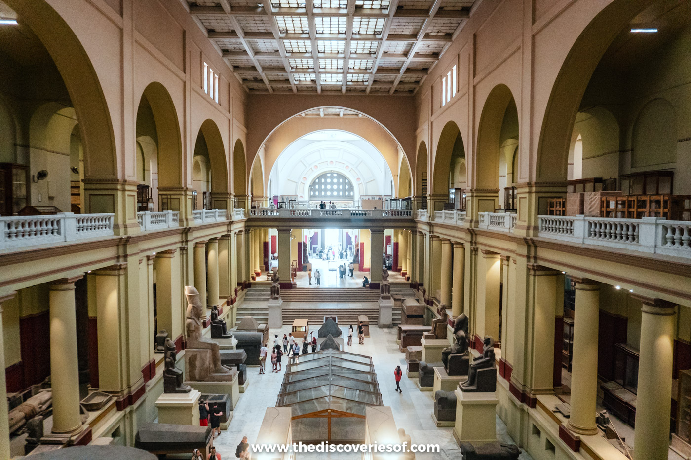 The central atrium of the Egyptian Museum in Cairo, lined with statues and galleries on two floors