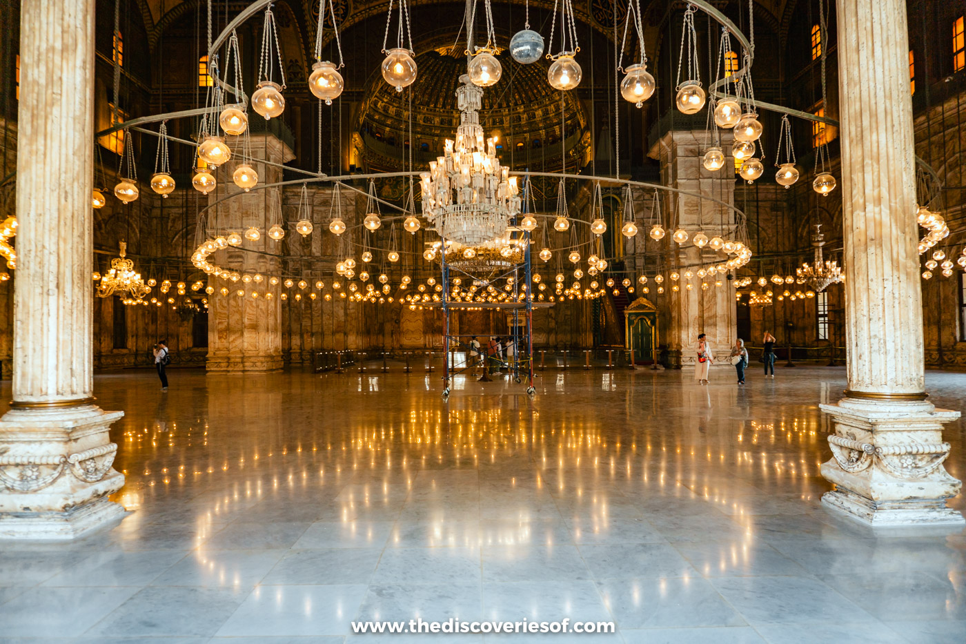 Rings of hanging lamps and a chandelier lighting the prayer hall of the Mosque of Muhammad Ali in Cairo