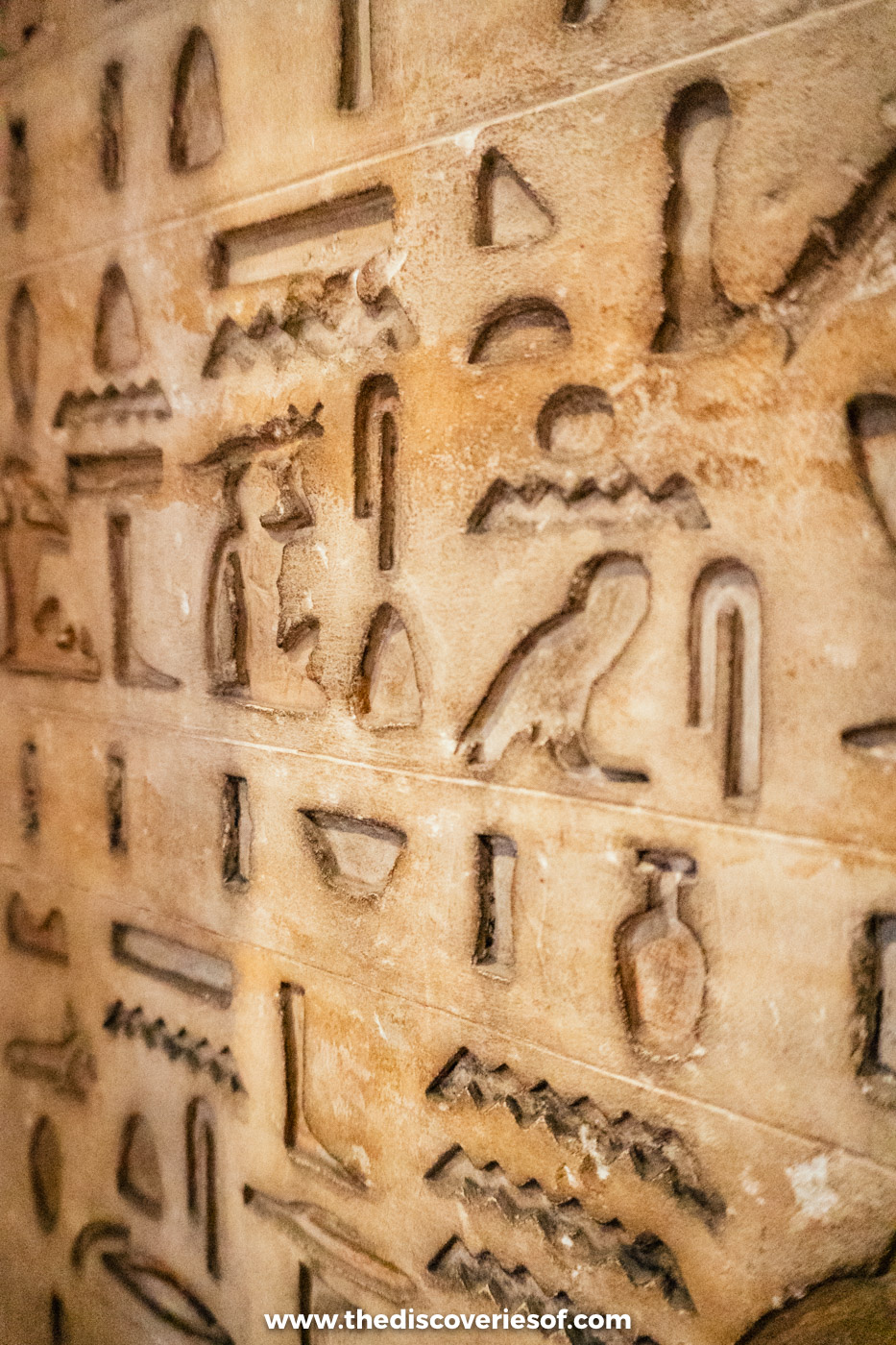 Close-up of hieroglyphs carved deep into a limestone block in the Egyptian Museum in Cairo
