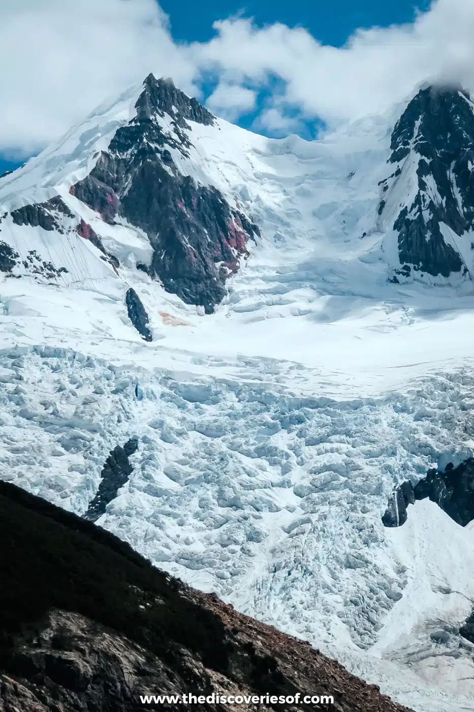 Glacier tumbling down between snowy peaks above Laguna Torre, El Chaltén, Argentina