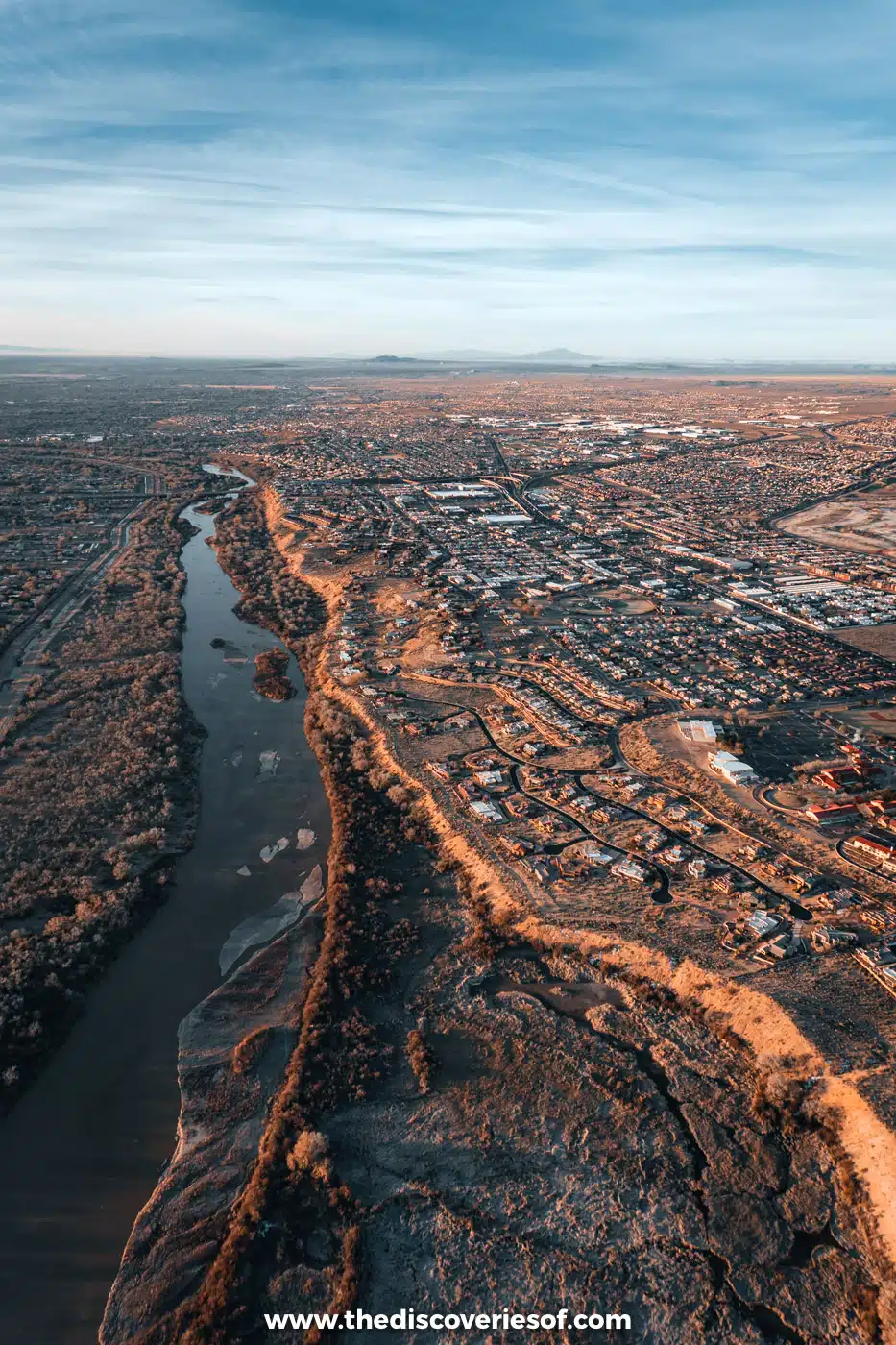 The Rio Grande winding through its bare winter cottonwood bosque, seen from a hot air balloon over Albuquerque