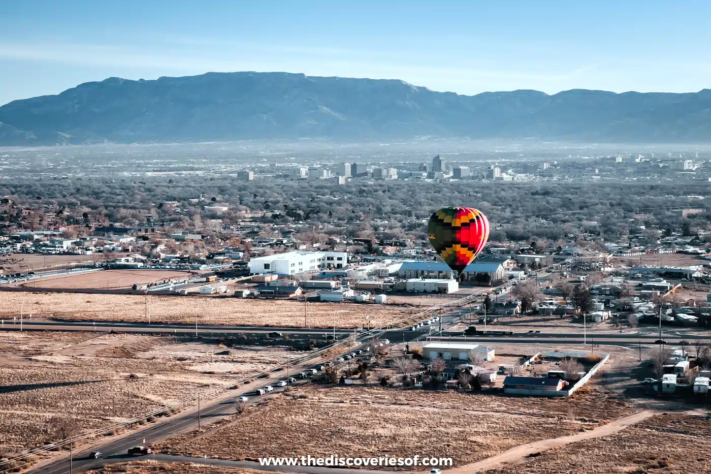 Downtown Albuquerque's tower blocks below the Sandia Mountains, seen from a hot air balloon