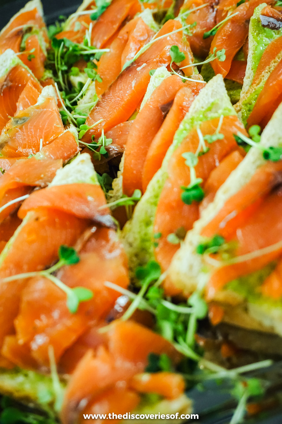Plate of Icelandic smoked salmon canapés topped with herbs and cress