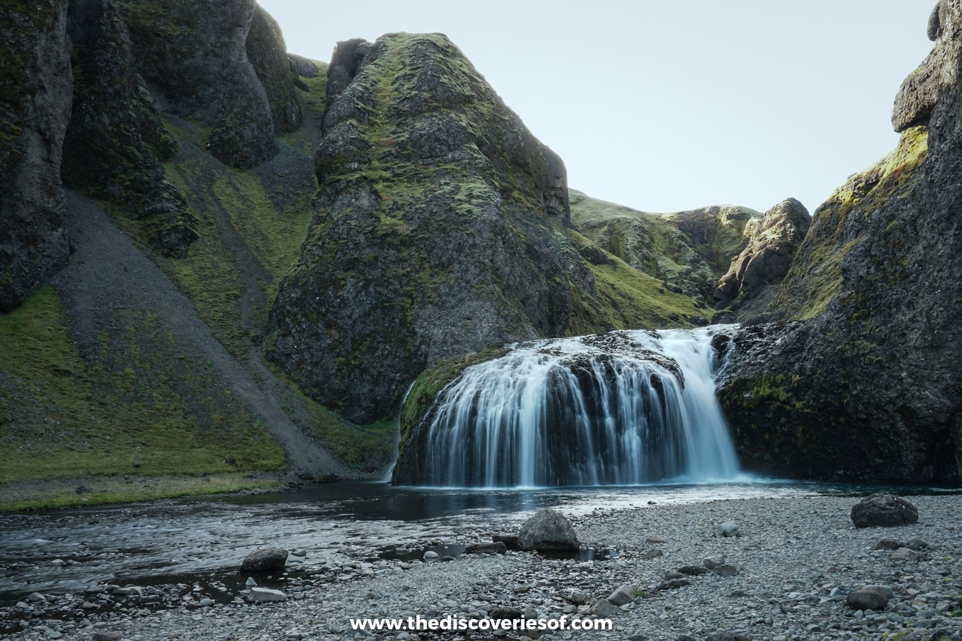 Stjórnarfoss waterfall spilling into a pool in a rock amphitheatre of green moss near Kirkjubæjarklaustur