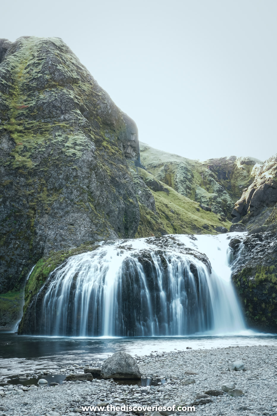 Stjórnarfoss pouring over a mossy rock ledge into a pool in its rock amphitheatre near Kirkjubæjarklaustur