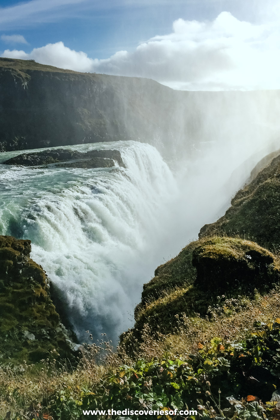 The lower drop of Gullfoss plunging into its narrow crevice, seen from the mossy clifftop above