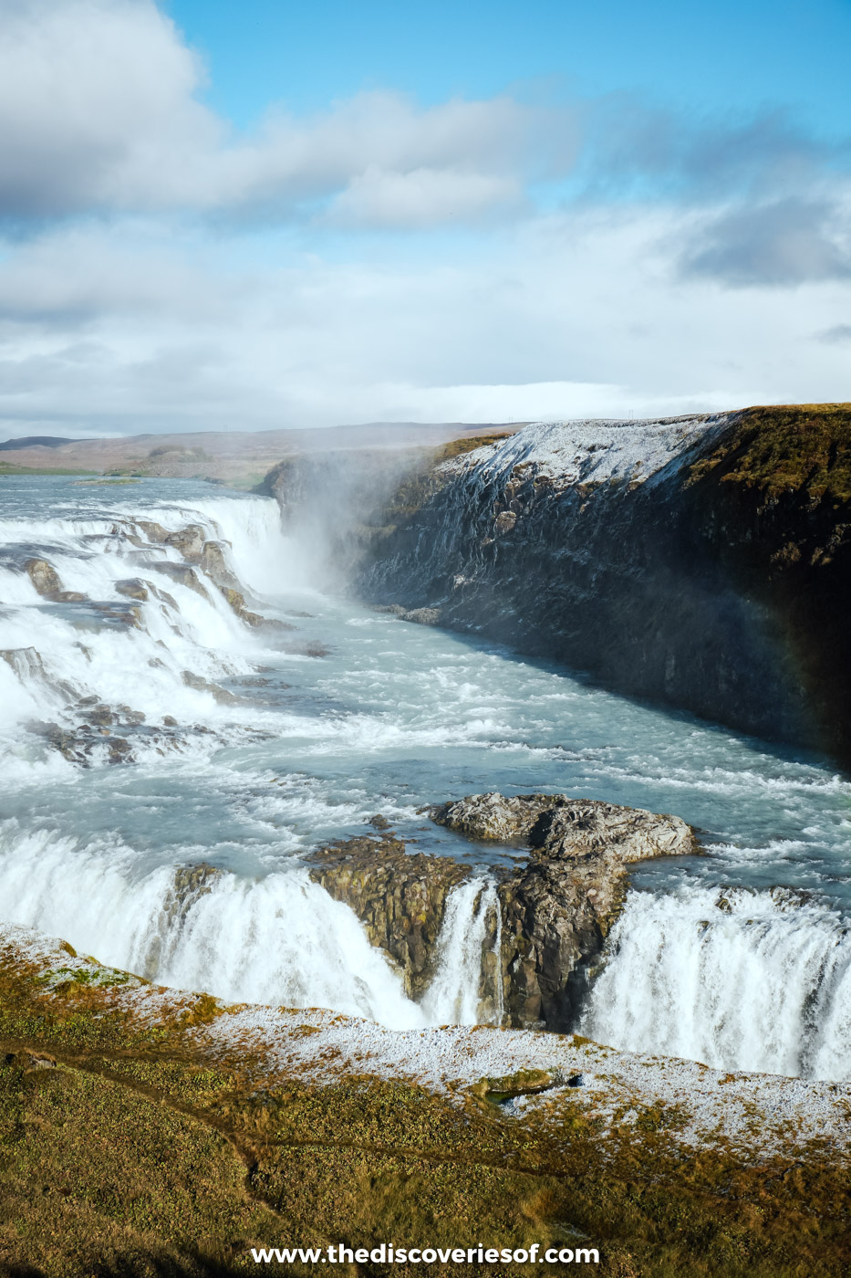 The stepped upper cascades of Gullfoss pouring towards the canyon on a bright, sunny September afternoon