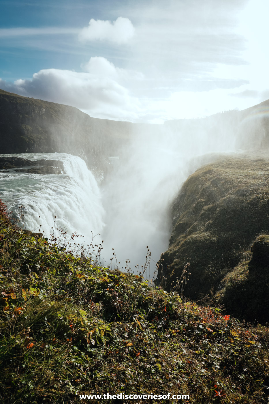Spray billowing out of the canyon below the second drop of Gullfoss, with mossy cliffs in the foreground