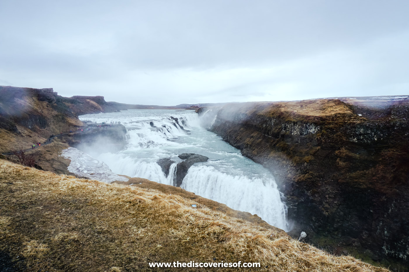 Spray drifting across the canyon in front of Gullfoss waterfall on a grey evening in early May