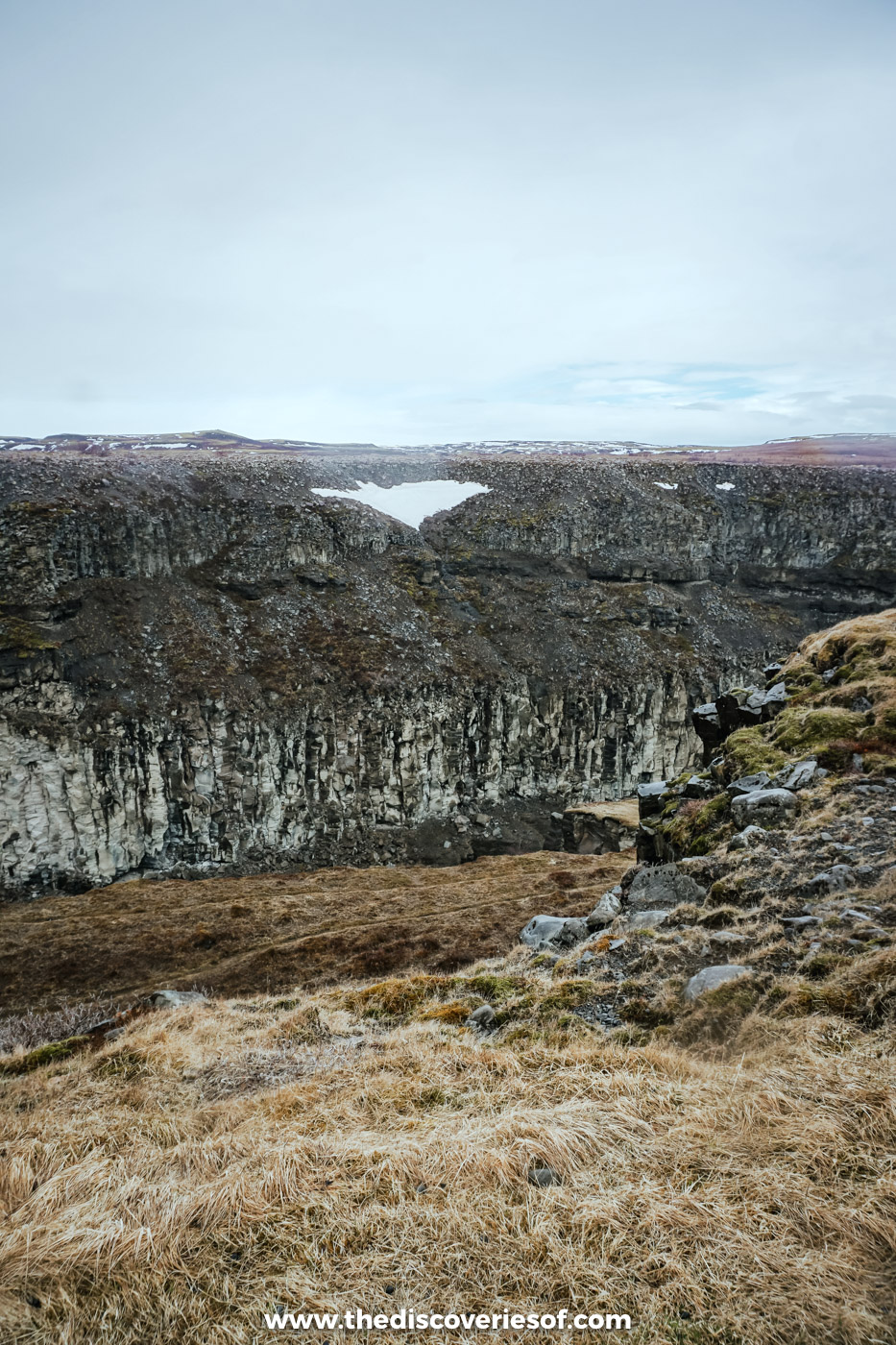 The dark basalt walls of the Hvítá canyon below Gullfoss, with patches of late snow in early May