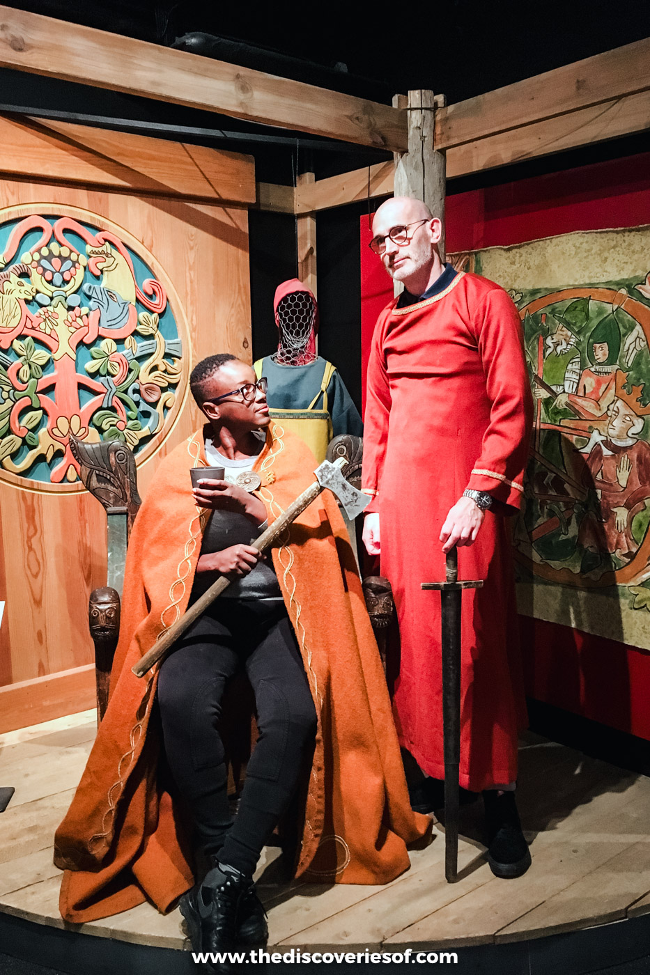 Julianna in Viking costume seated beside a man in a red Viking robe at the Saga Centre feast in Hvolsvöllur