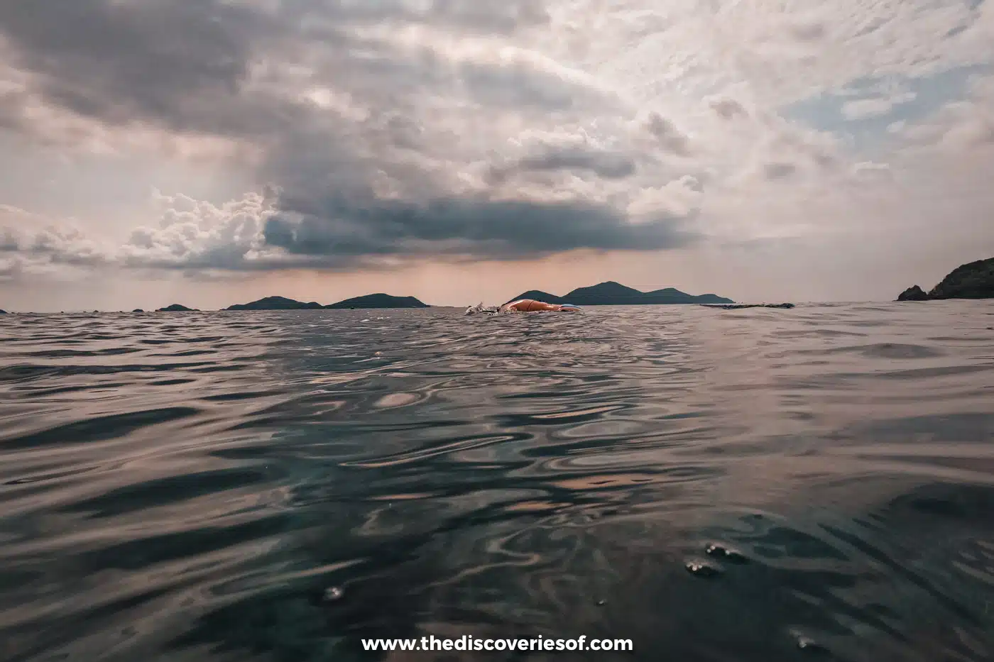 Calm grey sea and distant islands under a cloudy sky between El Nido and Coron