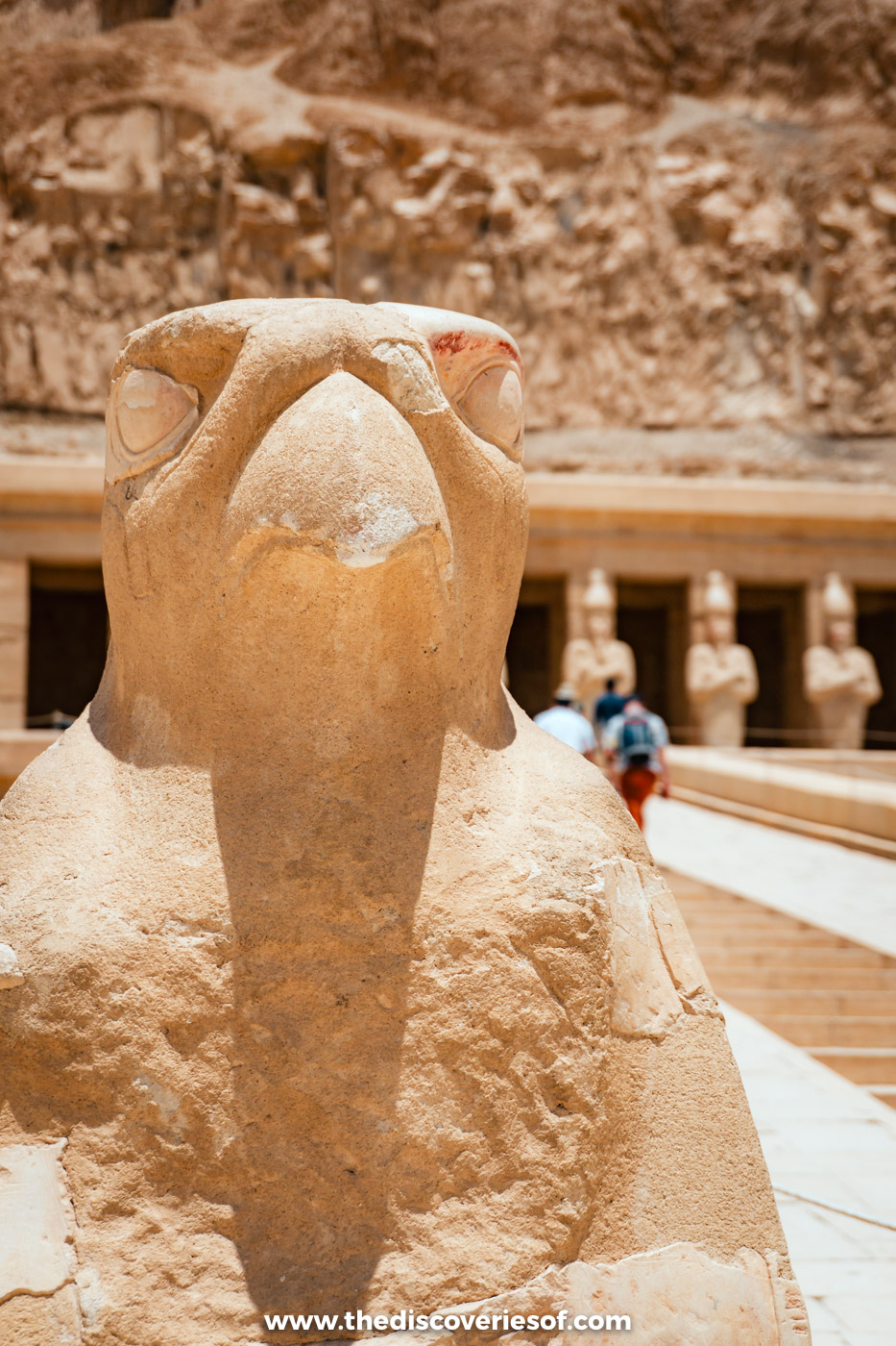 A weathered stone falcon of Horus beside the upper ramp of the Mortuary Temple of Hatshepsut in Luxor