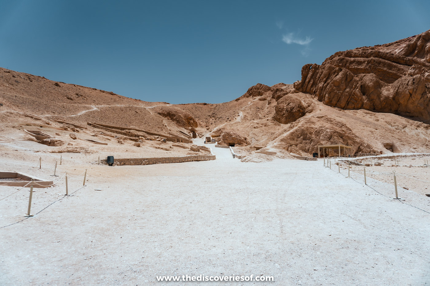 Gravel path and low walls leading between rocky desert hills in the Valley of the Queens, Luxor