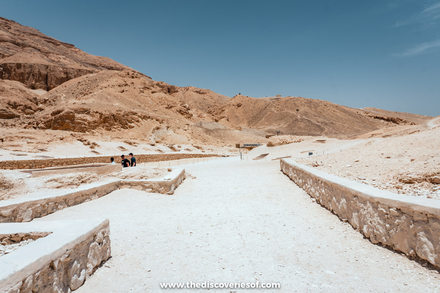 Walled gravel paths between the tombs under desert hills in the Valley of the Queens, Luxor