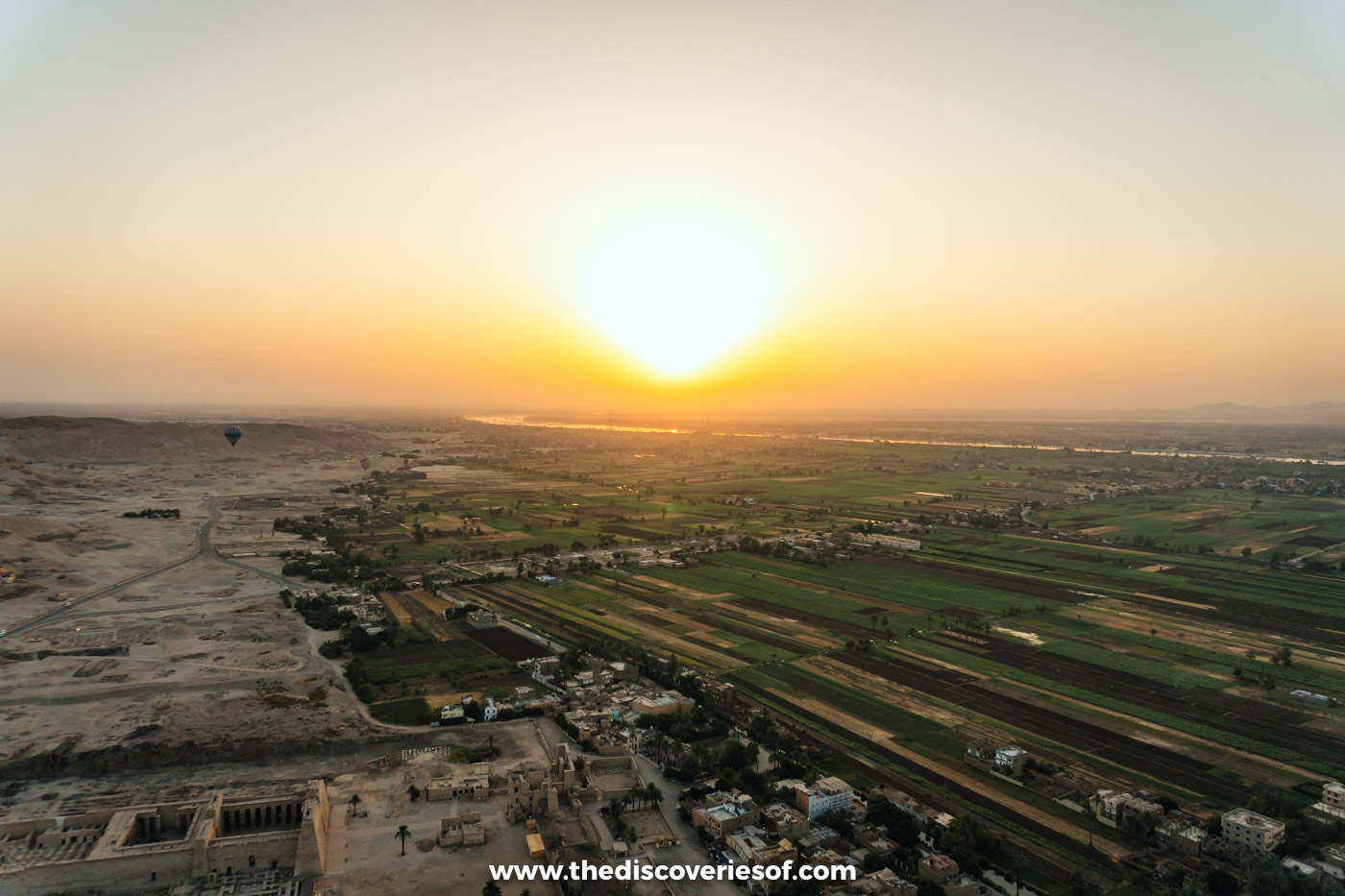 The sun rising over the Nile valley and West Bank fields, seen from a hot air balloon over Luxor